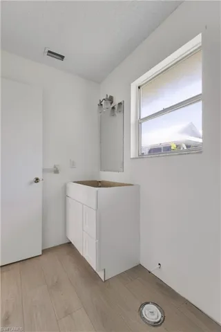 Bathroom featuring a textured ceiling and hardwood / wood-style floors