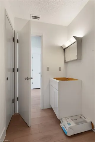 Bathroom featuring hardwood / wood-style floors and a textured ceiling