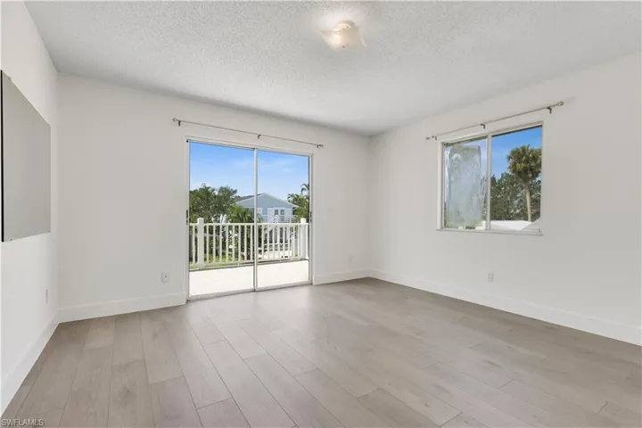 Unfurnished room featuring a textured ceiling and light hardwood / wood-style flooring