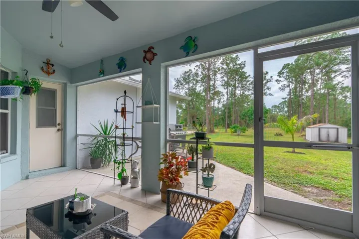 Sunroom / solarium featuring ceiling fan and a healthy amount of sunlight