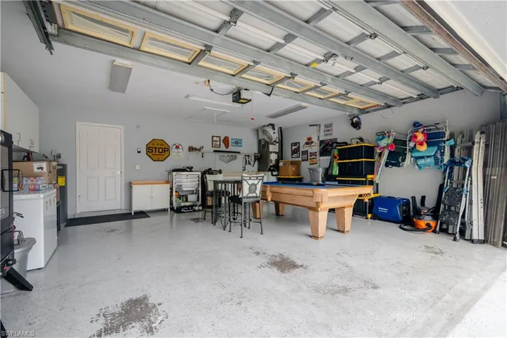 Garage featuring a garage door opener and washing machine and dryer