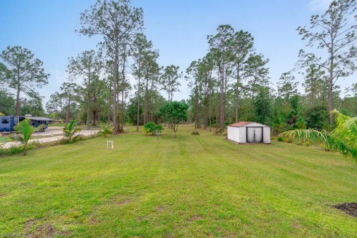 View of yard featuring a storage unit