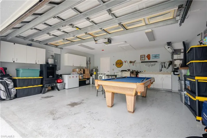 Garage featuring a garage door opener and electric panel
