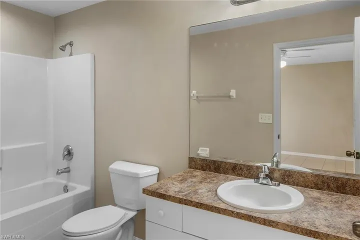 Bathroom featuring tub / shower combination and vanity
