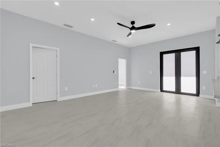 Spare room with recessed lighting, ceiling fan, and french doors