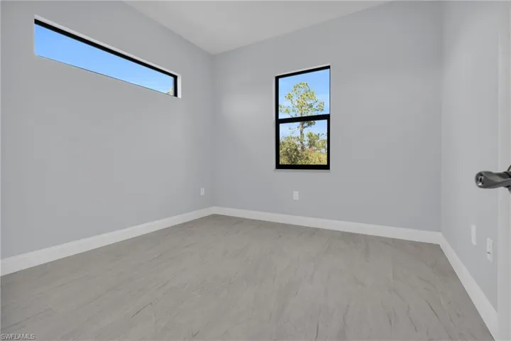 Unfurnished room featuring baseboards