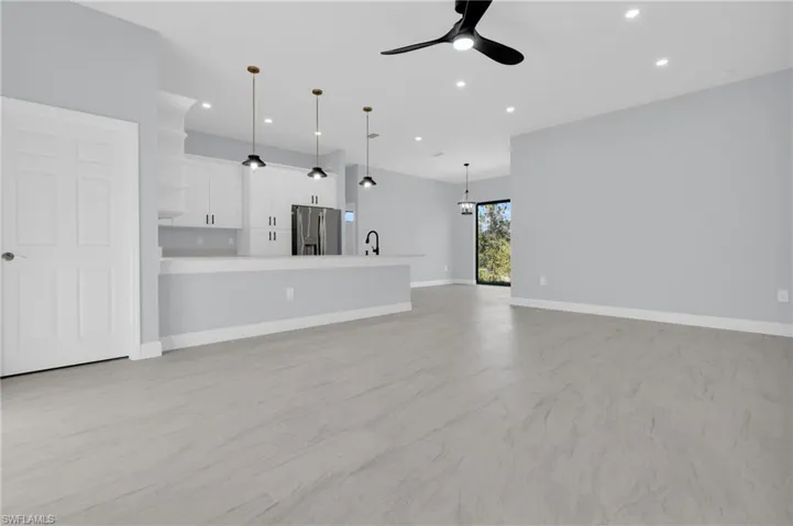 Unfurnished living room featuring recessed lighting and ceiling fan