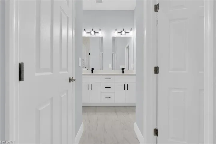 Full bath featuring double vanity
