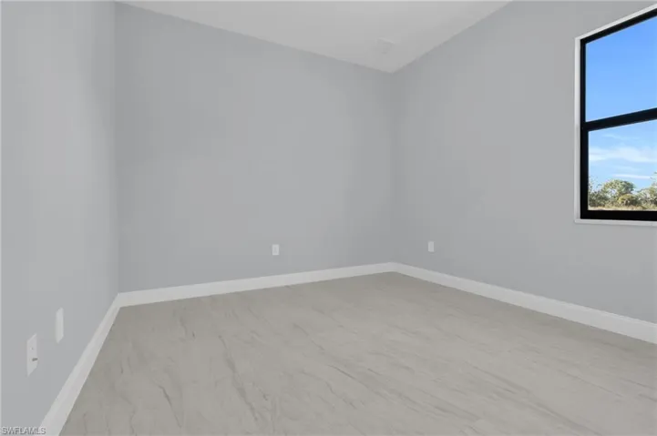 Spare room featuring baseboards