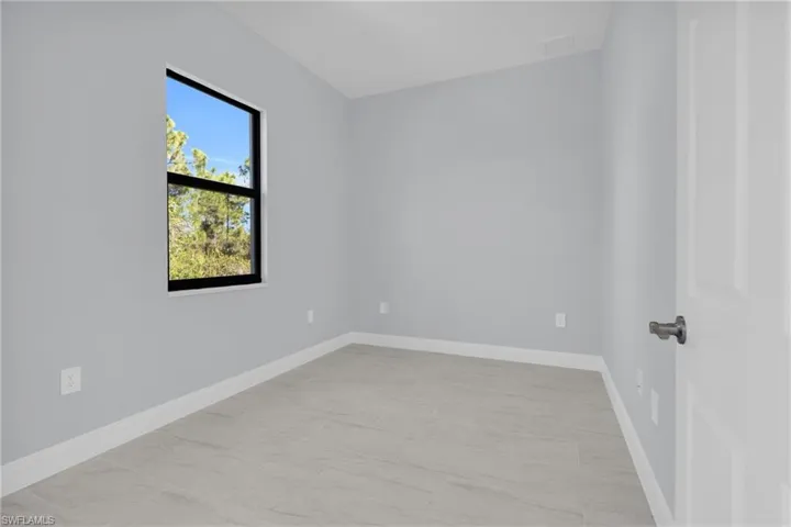 Empty room featuring baseboards