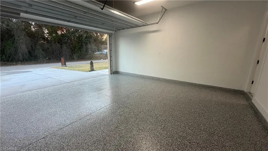 Garage featuring baseboards