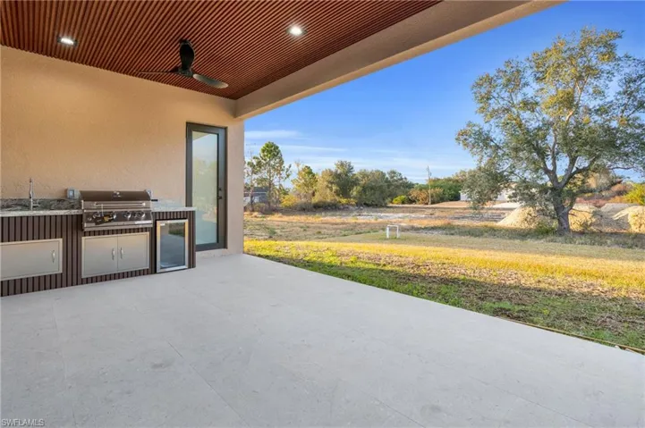 View of patio / terrace with exterior kitchen and a ceiling fan