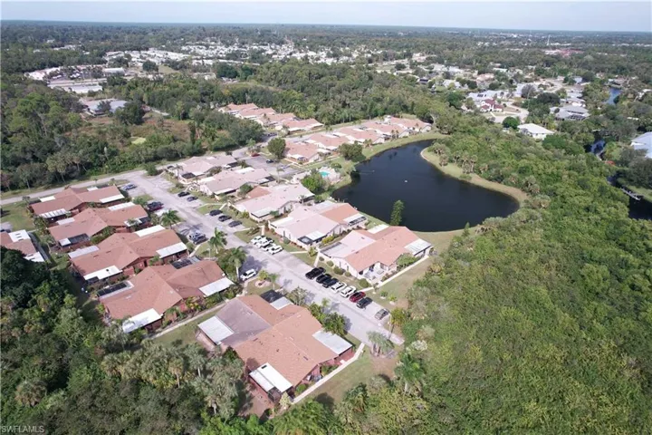 Aerial view of property's location with a large body of water and nearby suburban area