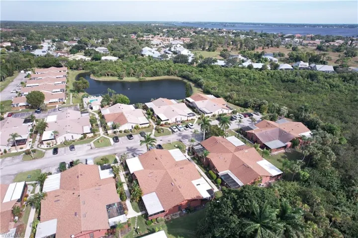 Aerial overview of property's location featuring a large body of water and nearby suburban area