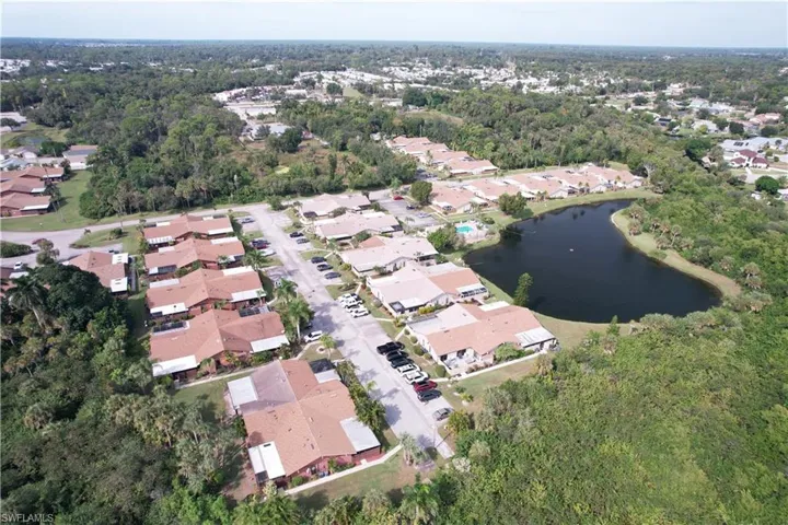 View of property location with a nearby body of water and nearby suburban area
