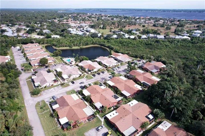 Aerial overview of property's location with a large body of water and nearby suburban area