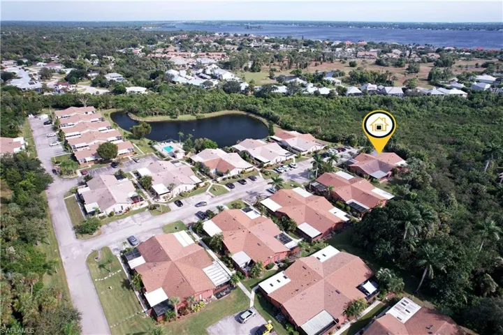 View of property location featuring a large body of water and nearby suburban area