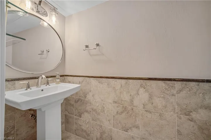 Bathroom featuring tile walls and a wainscoted wall