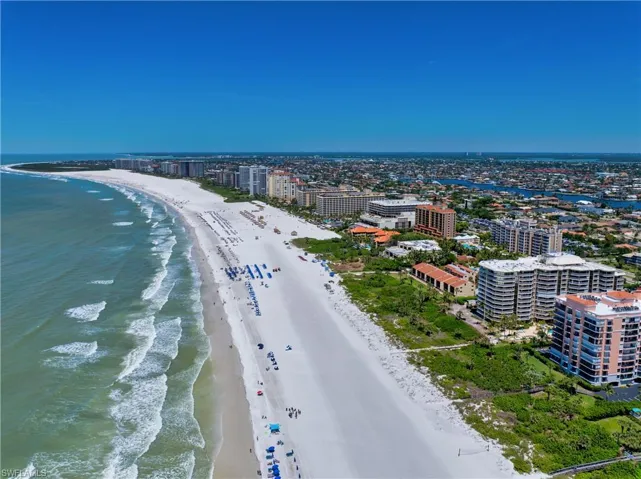 View of urban area featuring waterfront with a beach