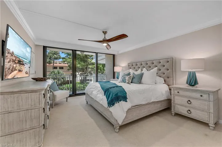 Bedroom with floor to ceiling windows, ornamental molding, light colored carpet, access to outside, and a ceiling fan