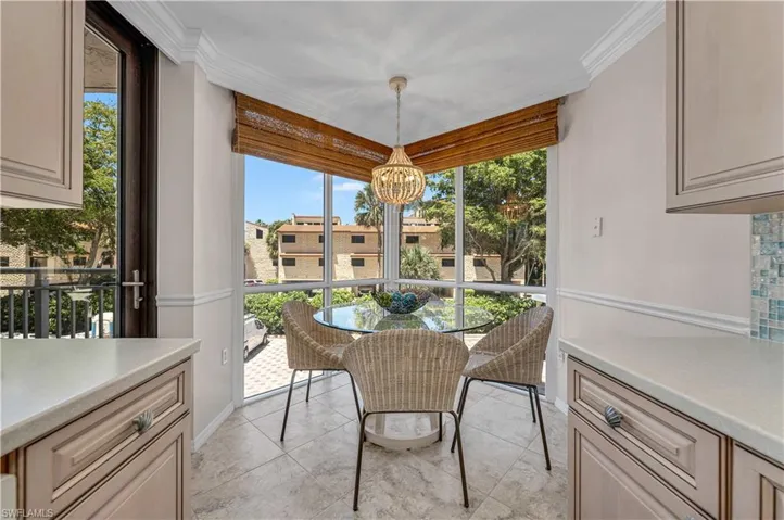 Dining space with a chandelier, crown molding, and light tile patterned flooring