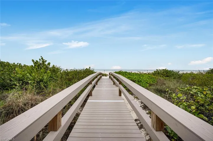 View of home's community with view of water and beach