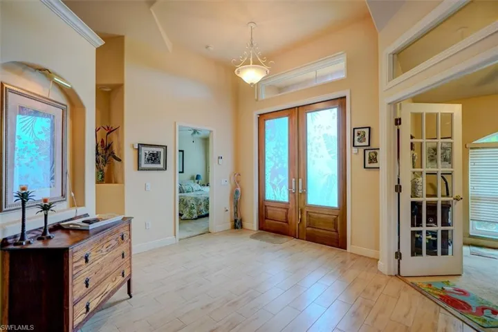 Foyer entrance with french doors and light hardwood / wood-style floors