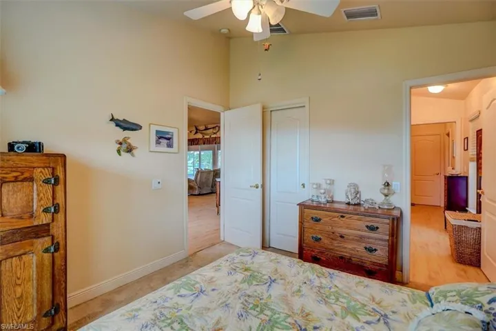 Front spare Bedroom featuring a closet, vaulted ceiling, ceiling fan, carpet