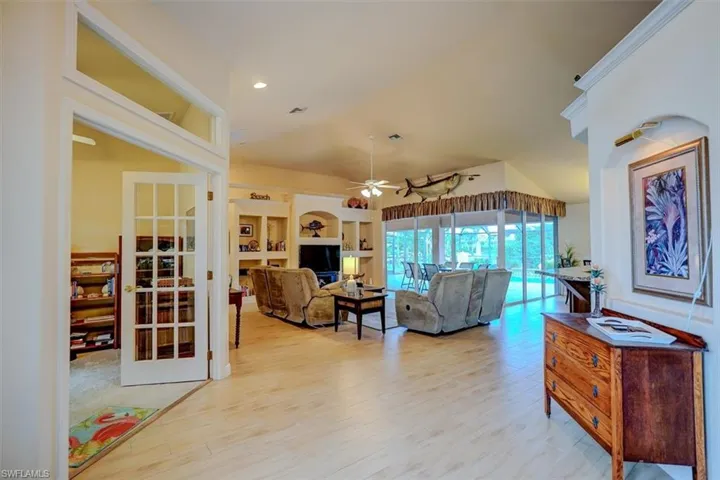 Living room with ceiling fan and light hardwood / wood-style flooring