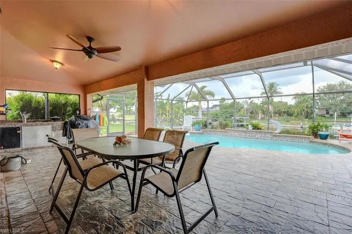 Sunroom / solarium featuring a swimming pool, vaulted ceiling, and ceiling fan