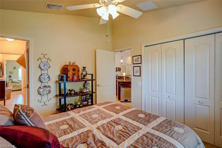 Bedroom featuring ceiling fan, a closet, and vaulted ceiling