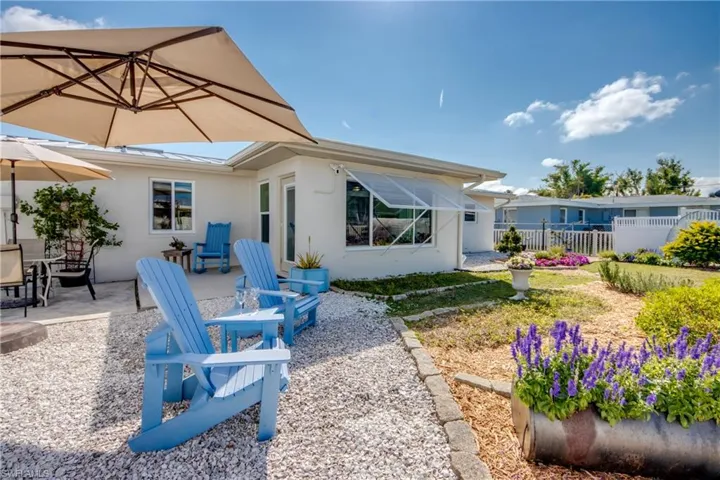 Rear view of property with a patio and stucco siding