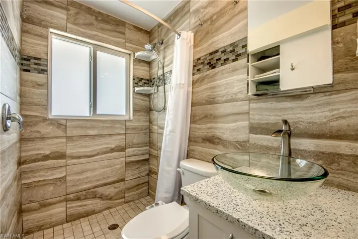 Full bath featuring vanity and a shower stall