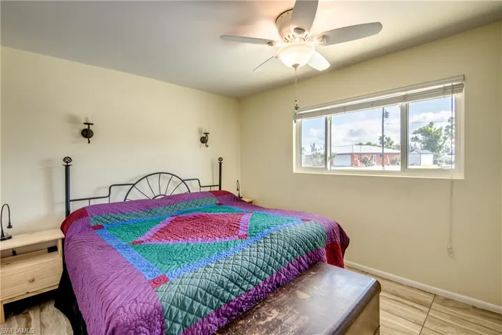 Bedroom with baseboards and a ceiling fan