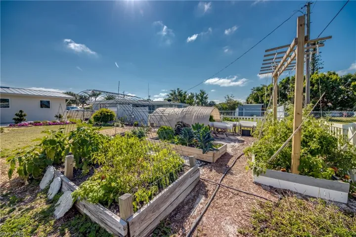 View of yard with a vegetable garden and an outbuilding