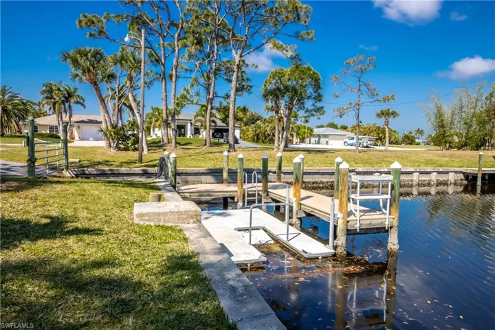 Dock with a yard and a water view
