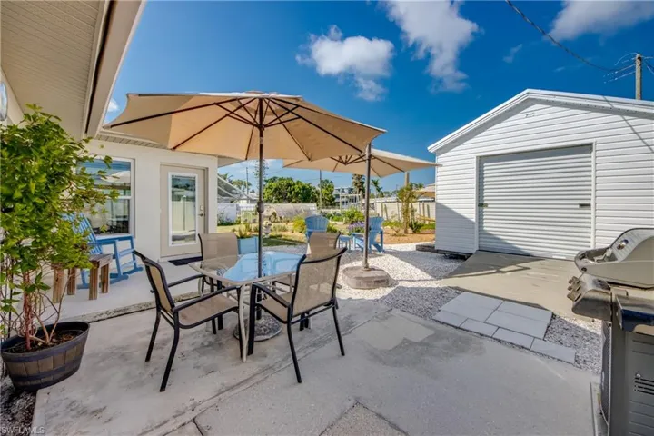 View of patio / terrace with an outdoor structure, outdoor dining area, and area for grilling