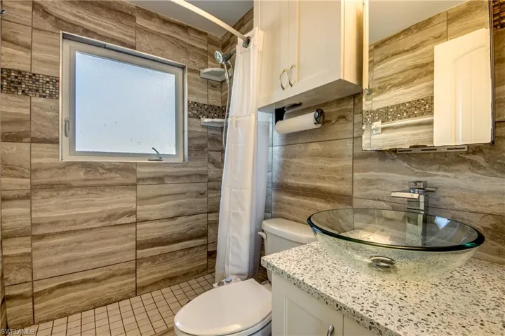 Full bathroom with a stall shower and vanity