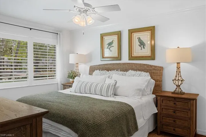 Bedroom featuring a ceiling fan and crown molding