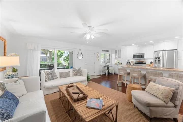 Living room with recessed lighting, crown molding, dark wood-style floors, and ceiling fan