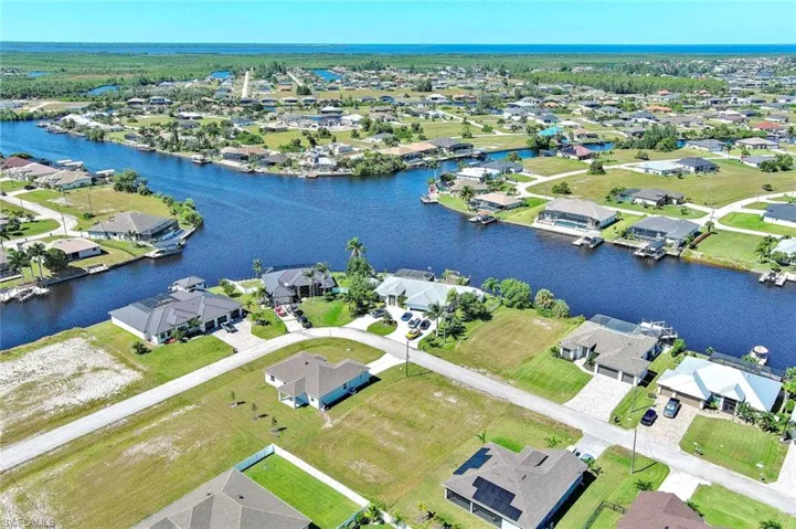 Aerial perspective of suburban area featuring a nearby body of water
