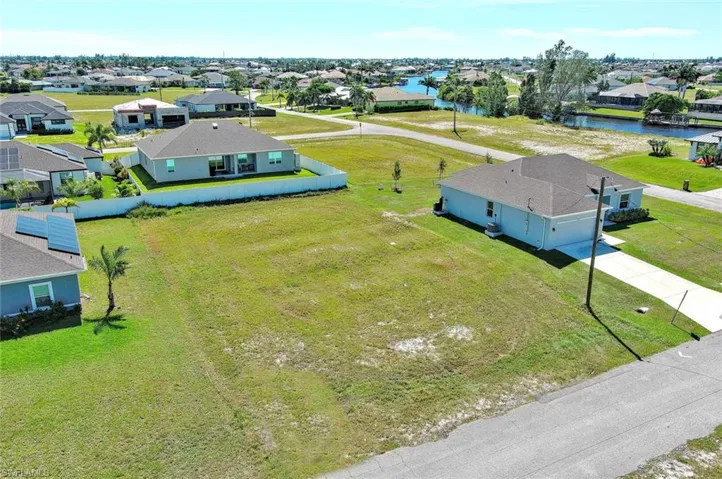 Aerial perspective of suburban area with a large body of water