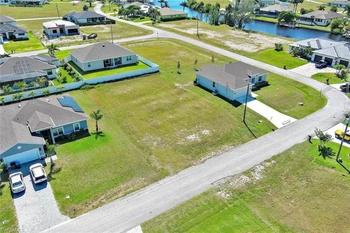 Aerial perspective of suburban area with a nearby body of water