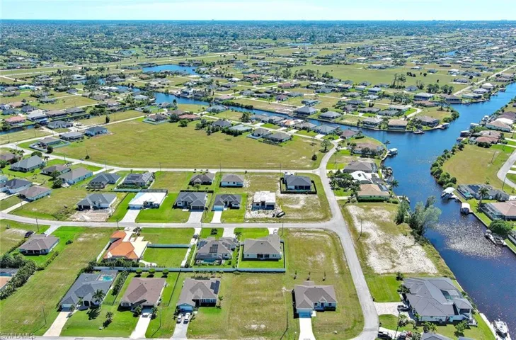Aerial view of property's location with nearby suburban area