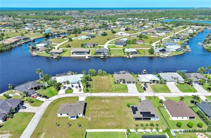 Aerial overview of property's location featuring nearby suburban area and a large body of water