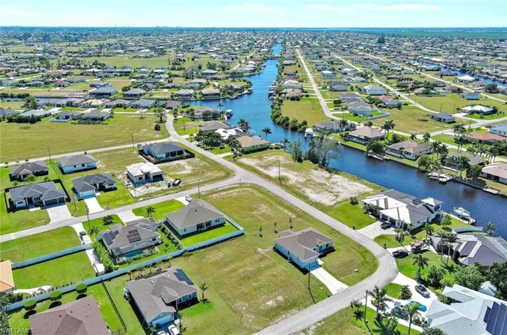 Aerial view of residential area featuring a large body of water