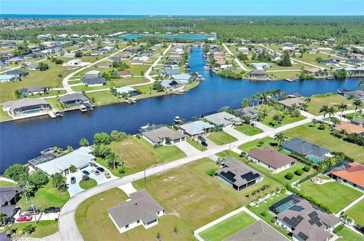 Aerial view of property's location featuring nearby suburban area and a large body of water