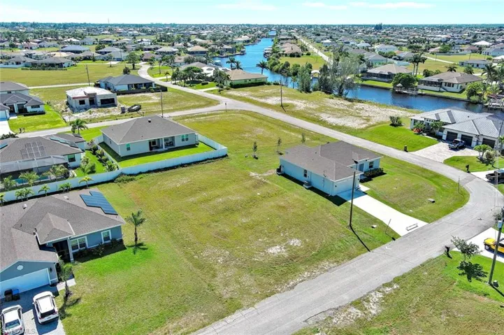 Aerial perspective of suburban area with a large body of water