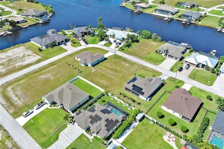 Aerial view of residential area featuring a large body of water