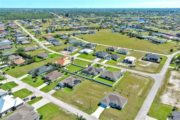 Aerial overview of property's location with nearby suburban area and a nearby body of water